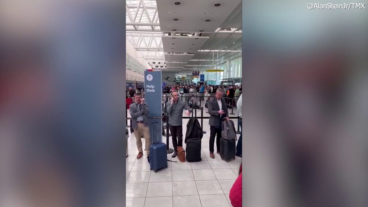 People crowd departure gate of BWI Airport following massive power outage