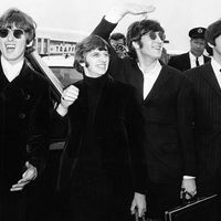 British rock group The Beatles, waving to screaming fans en route to Boston, Massachusetts airport (from l to r) George Harrison, Ringo Starr, John Lennon, and Paul McCartney, on August 12, 1966.