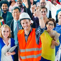 A group of diverse individuals, who represent various occupations, stand with their arms raised in the air. labor day; laborers; construction worker; teacher; nurse; doctor; assistant; office staff; blue collar; workforce