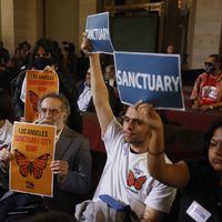 Los Angeles City Council meeting in which audience members hold up signs supporting a sanctuary city measure