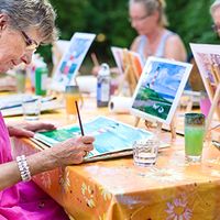 A group of people are painting outdoors.