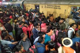 Passengers jostle with each other to board a train at the New Delhi Railway station, in New Delhi, India, Thursday, Feb.15, 2025. (AP Photo)