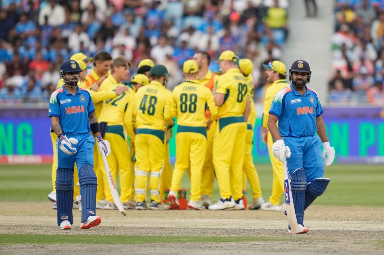 India's captain Rohit Sharma, right, walks off the field after losing his wicket as India's Virat Kohli, left, watches during the ICC Champions Trophy semifinal cricket match between India and Australia at Dubai International Cricket Stadium in Dubai, United Arab Emirates, Tuesday, March 4, 2025. (AP Photo/Altaf Qadri)