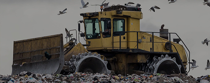 tracktor in a field of garbages