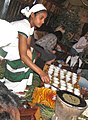 Image 30An Ethiopian woman preparing Ethiopian coffee at a traditional ceremony. She roasts, crushes, and brews the coffee on the spot. (from Culture of Africa)