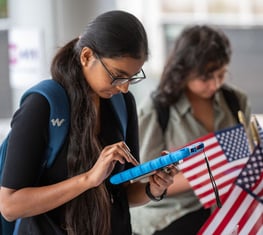 A young person registering to vote at a League event