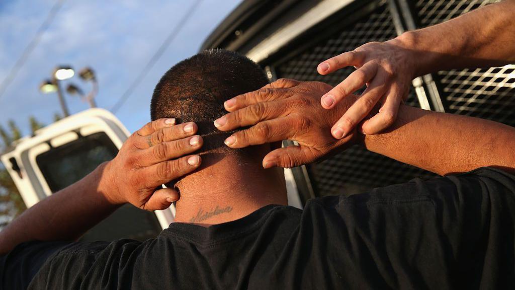 ICE agents detaining an immigrant in California in 2015. 