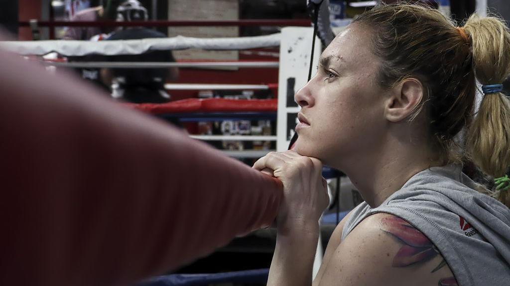 Heather Hardy holds the rope on a boxing ring