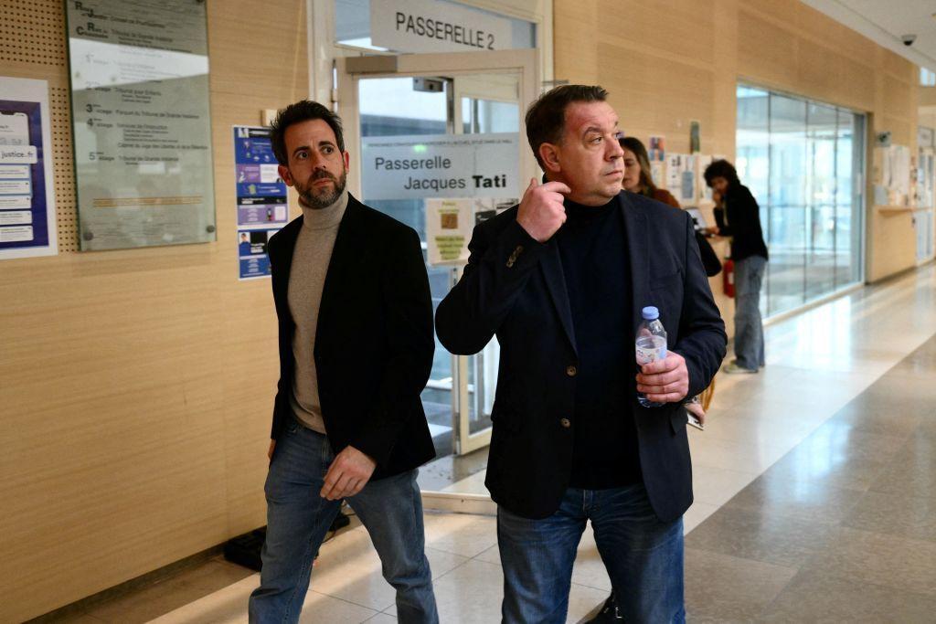 Florian, the youngest sibling of the family (L), and his brother David in a corridor during the trial