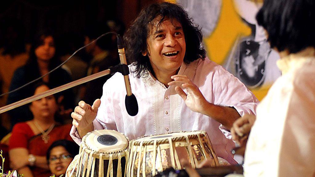 Indian tabla player Ustad Zakir Hussain performs with Mandolin player U. Srinivas for the 14th Vasantotsav in Mumbai on February 27, 2014. 