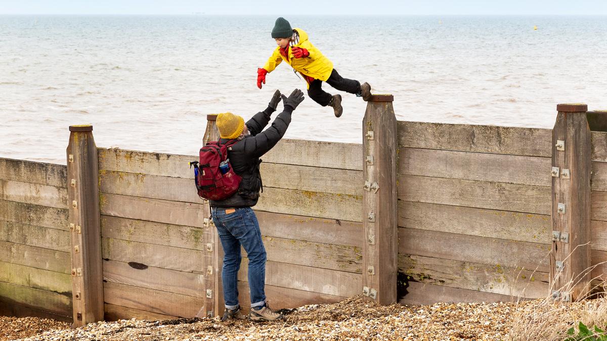 Man catches a jumping boy