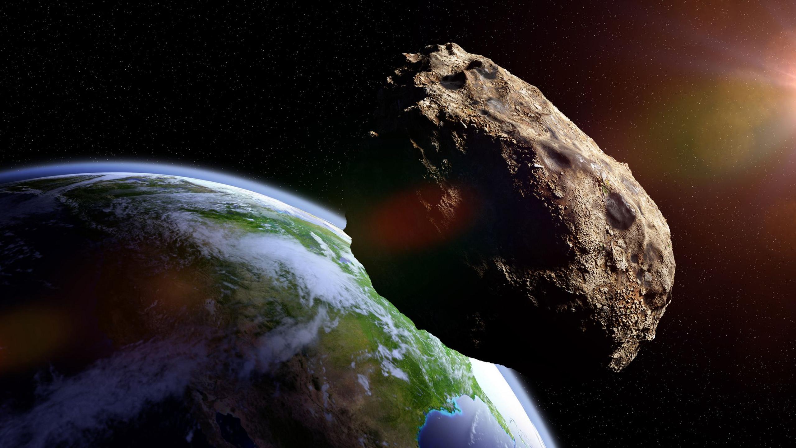 Illustration showing meteorite close to planet Earth