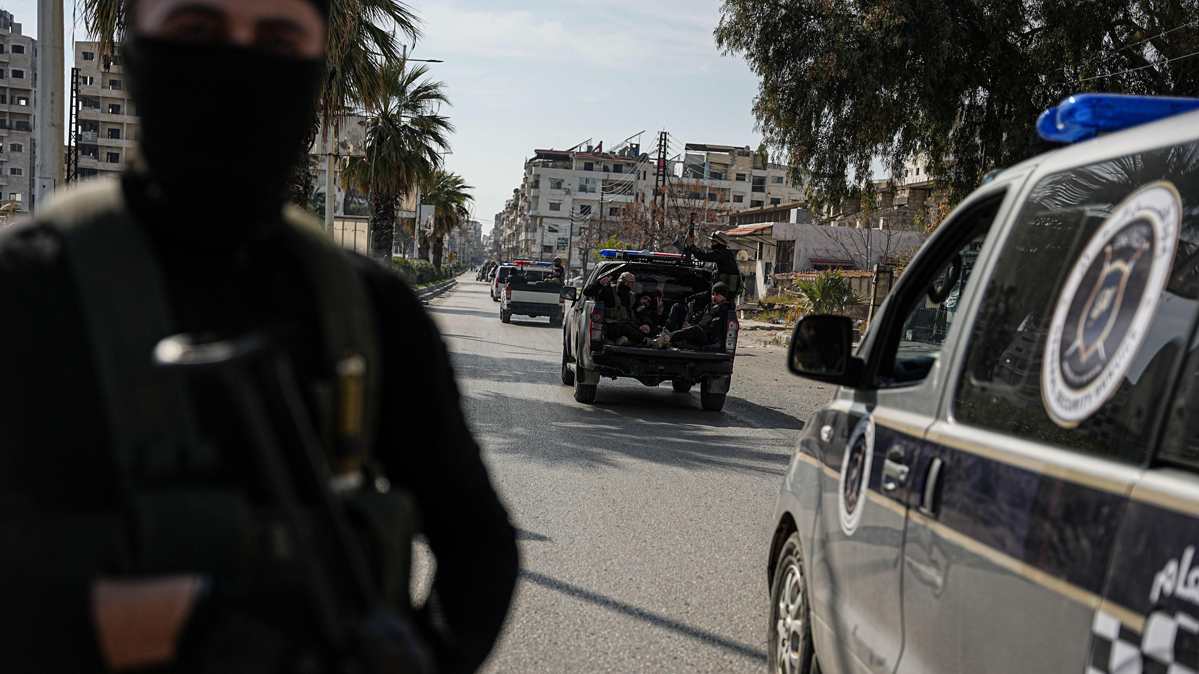 Syrian security forces patrol a street in Jableh, Latakia province, Syria (9 March 2025)