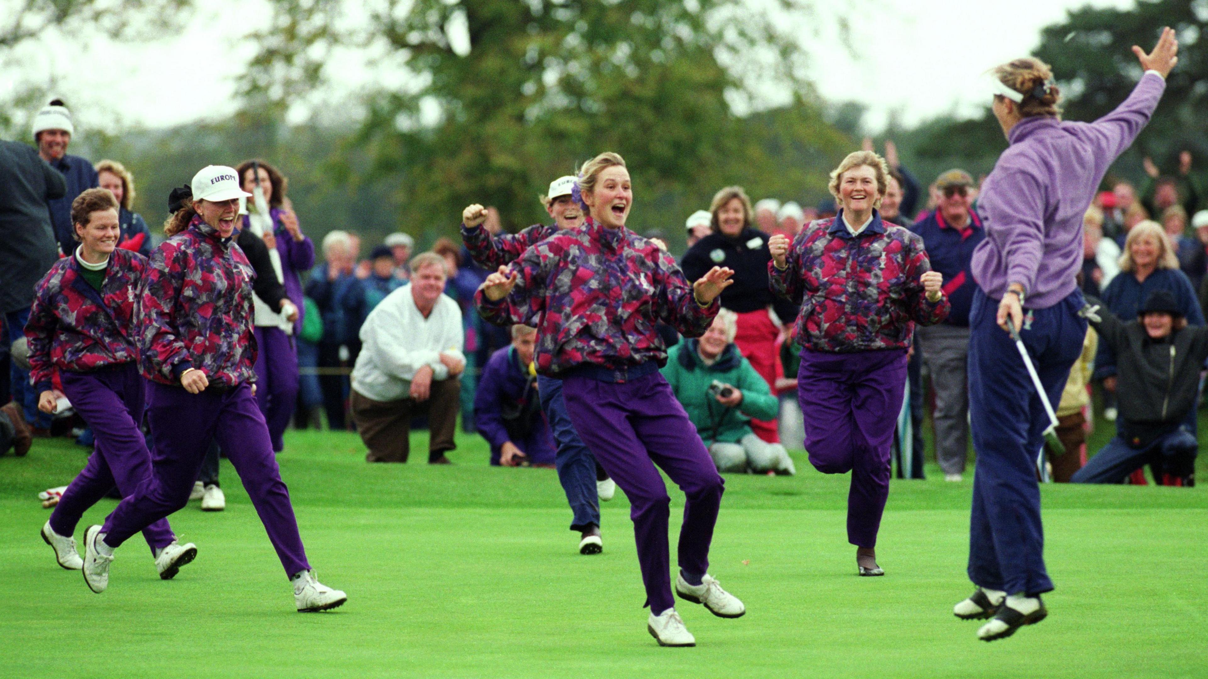 Europe's players run on to the green to celebrate Solheim Cup victory in 1992