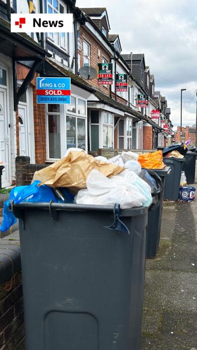 Several black wheelie bins overflowing with rubbish on a Birmingham street