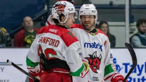 Cardiff Devils' Cole Sanford celebrates scoring with a team-mate Joey Martin