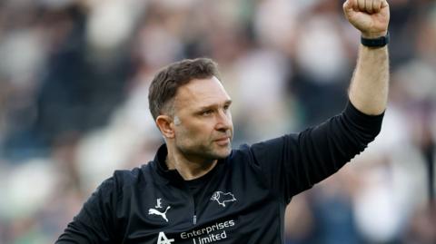 Derby boss John Eustace raises a fist in celebration