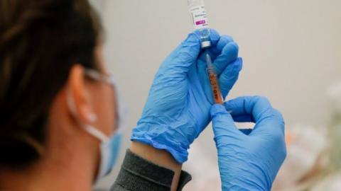 A dose of the AstraZeneca COVID-19 vaccine is prepared in a vaccination centre at Newmarket Racecourse