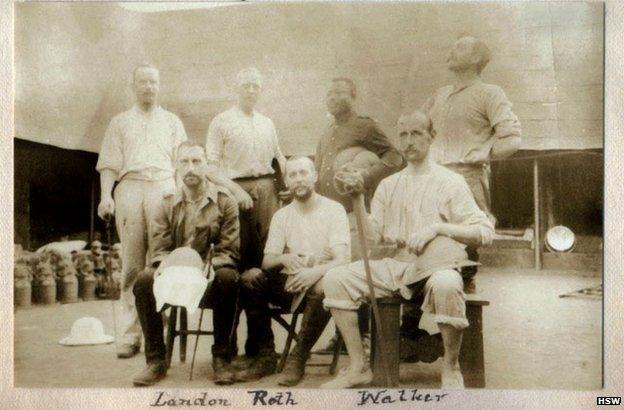 Captain Walker, seated, on the right, in Benin City after British troops looted the palace