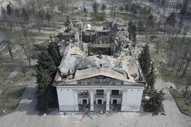 A picture of the Drama Theatre of Mariupol after the attack, with much of the roof collapsed