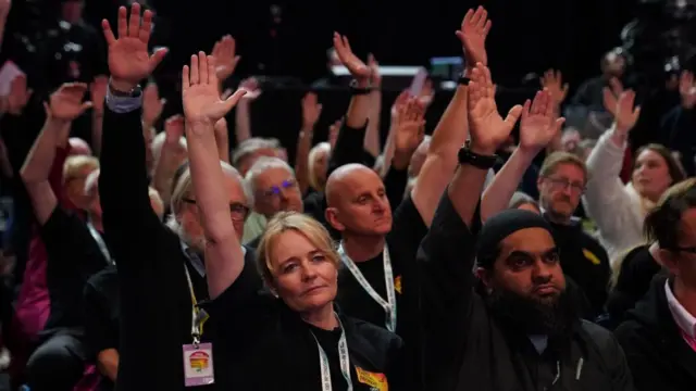 Unite the Union's Sharon Graham votes with a show of hands alongside other delegates in favour of a motion calling for the winter fuel cut to be reversed