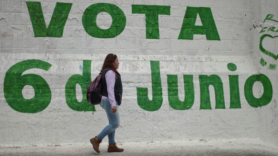 A woman walks past electoral propaganda in Ecatepec, State of Mexico, on 3 June 2021.