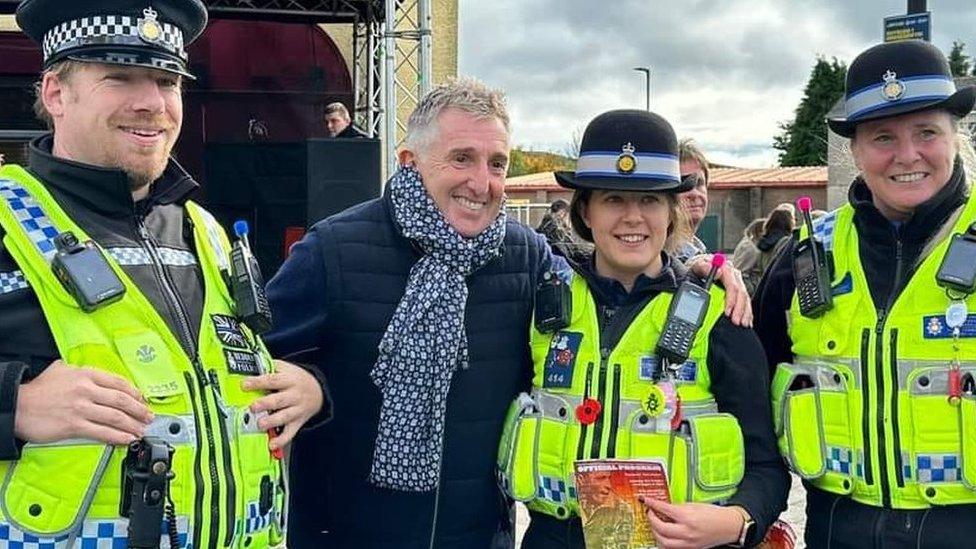 Former rugby union and league player Jonathan Davies with police officers at the unveiling of the statue