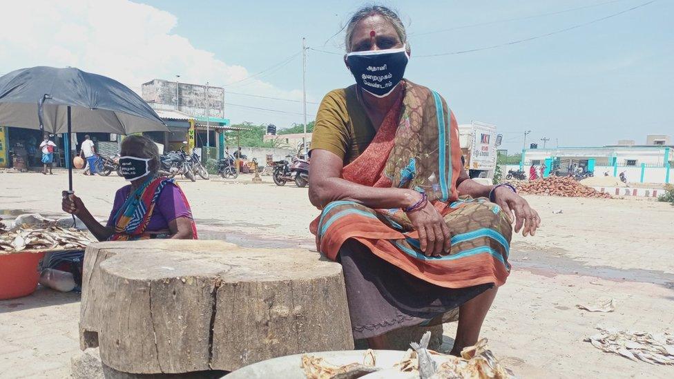 A woman fish vendor at a market in Tamil Nadu's Kattupalli