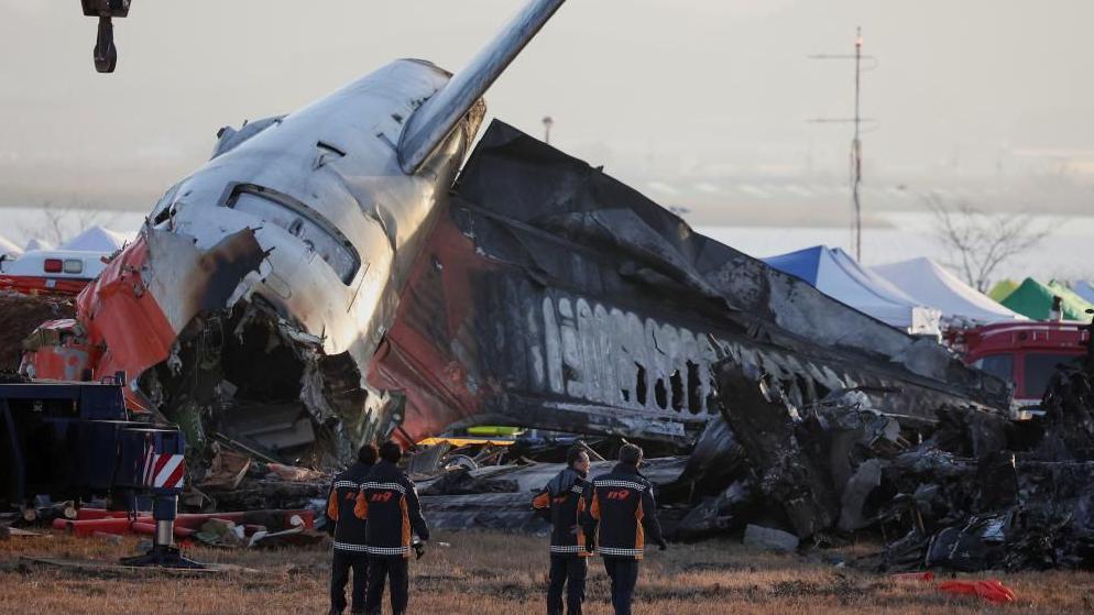 Firefighters take a look at the wreckage of the aircraft that crashed after it went off the runway, at Muan International Airport, in Muan, South Korea, December 31, 2024. REUTERS/Kim Hong-Ji