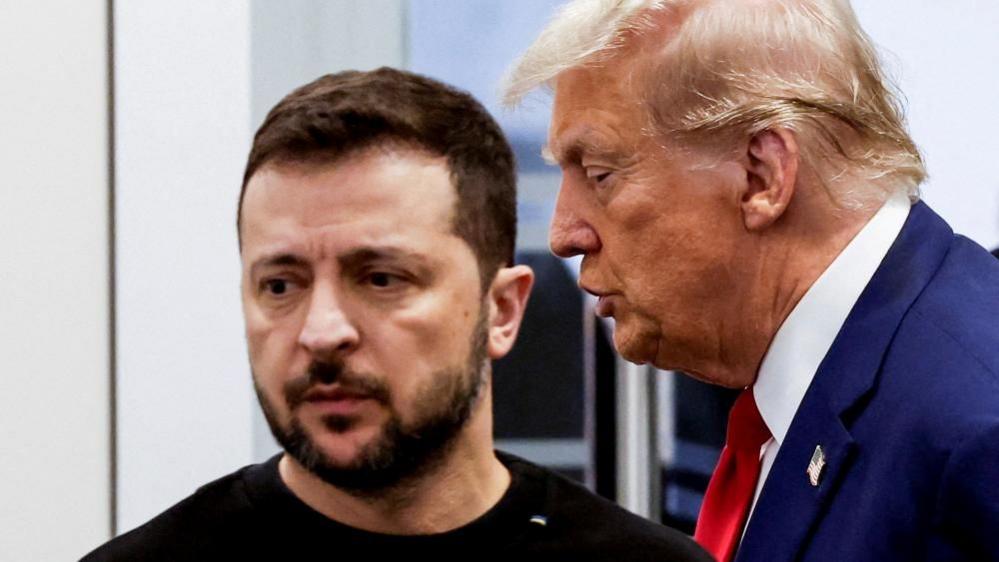 Donald Trump (R) and Ukraine's President Volodymyr Zelensky (L) meet at Trump Tower during the US presidential election campaign in September 2024. Zelensky is faced towards the camera but looking to the left, while Trump is side on and facing left.