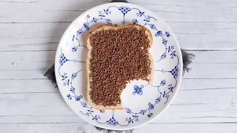 Bread with butter and chocolate hagelslag with one bite taken out (Credit: Getty Images)