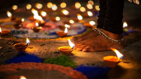 Aman Chotani/Getty Images At night, burning oil lamps cut through Varanasi's mist (Credit: Aman Chotani/Getty Images)