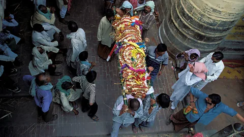 Yadid Levy/Alamy Parades of mourners routinely carry corpses through the streets of Varanasi towards the ghats (Credit: Yadid Levy/Alamy)