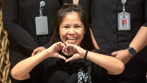 Mary Jane Veloso smiles and makes a hand heart gesture shortly before her repatriation to the Philippines, at Soekarno-Hatta International Airport in Tangerang, Indonesia, on 17 December 2024.