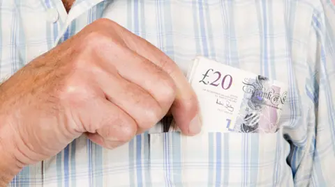 Man with banknotes in his pocket - stock photo