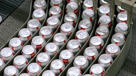 Cans of Coca-Cola Co. Diet Coke brand soda move along a conveyor belt at the Swire Coca-Cola bottling plant in West Valley City, Utah, U.S., on Friday, April 19, 2019.