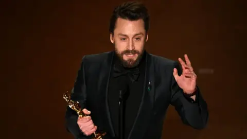 Getty Images US actor Kieran Culkin accepts the award for Outstanding Performance by a Male Actor in a Supporting Role for "A Real Pain" onstage during the 97th Annual Academy Awards at the Dolby Theatre in Hollywood, California on March 2, 2025.