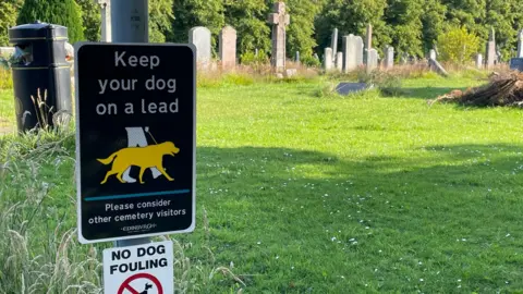 Keep your dog on a lead sign in a cemetery