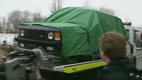 A Range Rover being transported under green tarpaulin after the Rettendon murders.