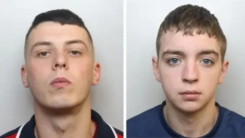 Avon and Somerset Police Side by side mugshots of Phillip Adams and Patrick James. Adams has short dark hair, dark eyes and is pictured against a grey background. He is tilting his head back slightly, with a blank expression. Patrick James has short light brown hair and blue eyes. He is also pictured against a grey background with a blank expression. 