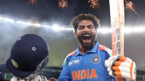 India's Ravindra Jadeja roars in celebration after hitting the winning runs in the Champions Trophy final