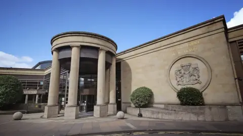 PA Media The front of the High Court building in Glasgow with four columns at the entrance