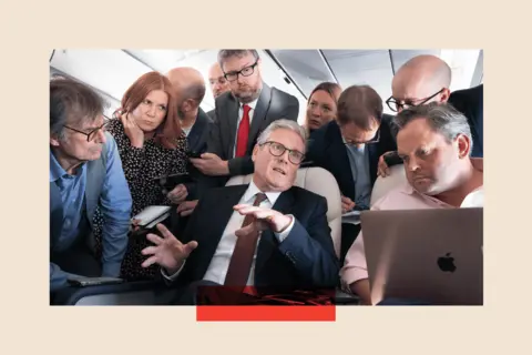 Getty Images Prime Minister Sir Keir Starmer talks to the media on board his plane as he flies to Washington DC for talks with President Joe Biden