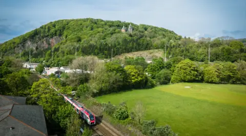 Transport for Wales A train travels on a train track