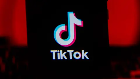 Getty Images TikTok logo displayed on a phone screen with a red background