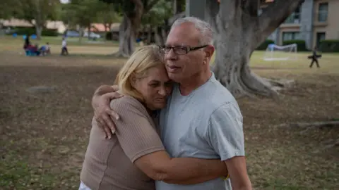 Simona Steinbrecher, the mother of freed hostage Doron Steinbrecher, hugs Avi Shamriz