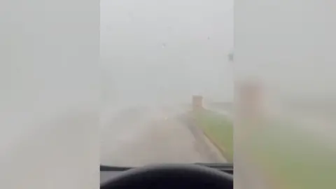 Woman gets stuck inside her car during a tornado.