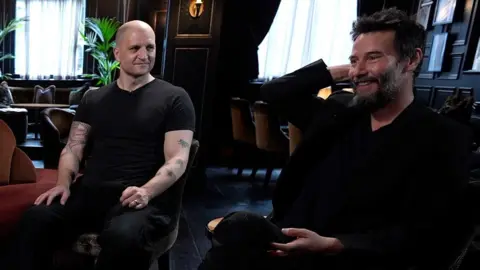 A picture of the author China Miéville and actor Keanu Reeves