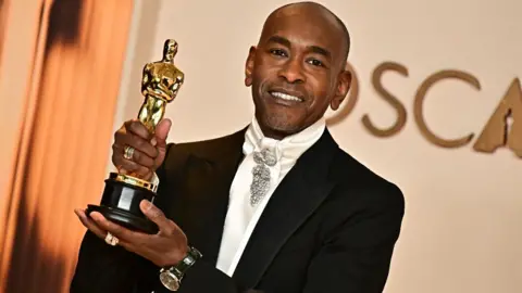 Getty Images US costume designer Paul Tazewell poses in the press room with the Oscar for Best Costume Design for "Wicked" during the 97th Annual Academy Awards at the Dolby Theatre in Hollywood, California on March 2, 2025