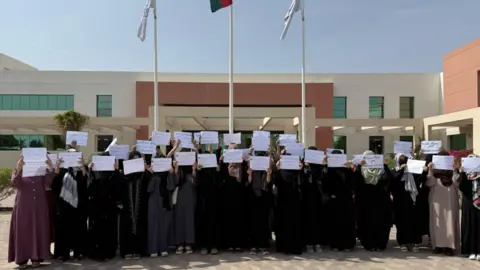 A group of Afghan women holding placards 